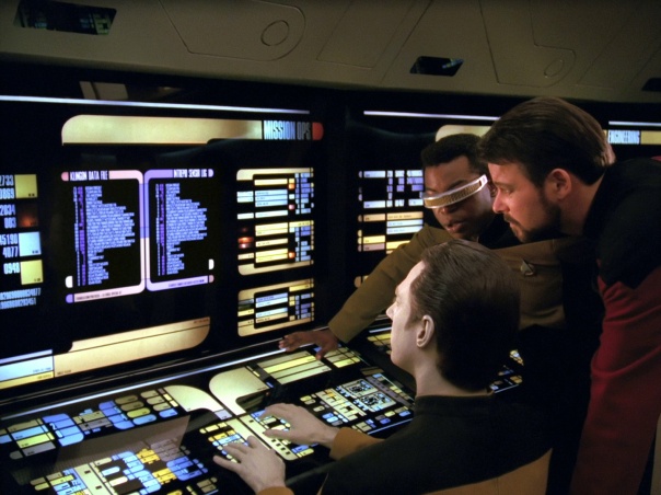 Data, Geordi, and Riker at one of many LCARS based terminals on the bridge of USS Enterprise D